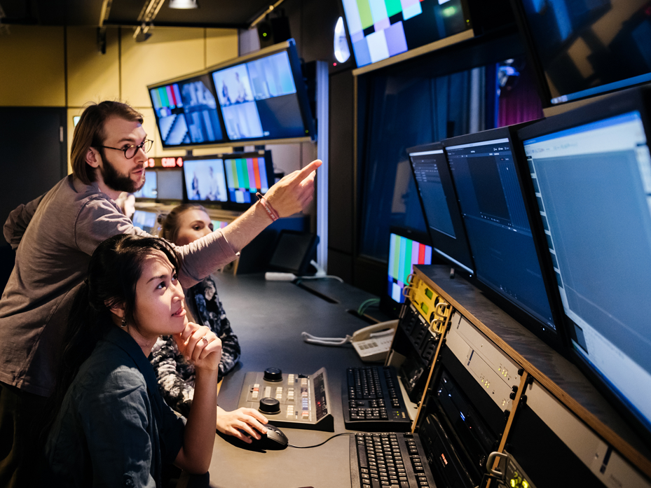 Broadcast Professionals Brainstorming Innovation with Consultants in TV Studio